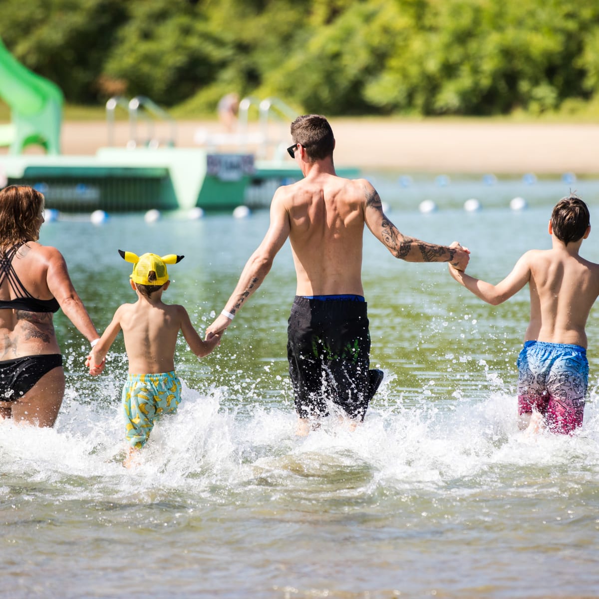 Family in the water at RécréoParc beach.