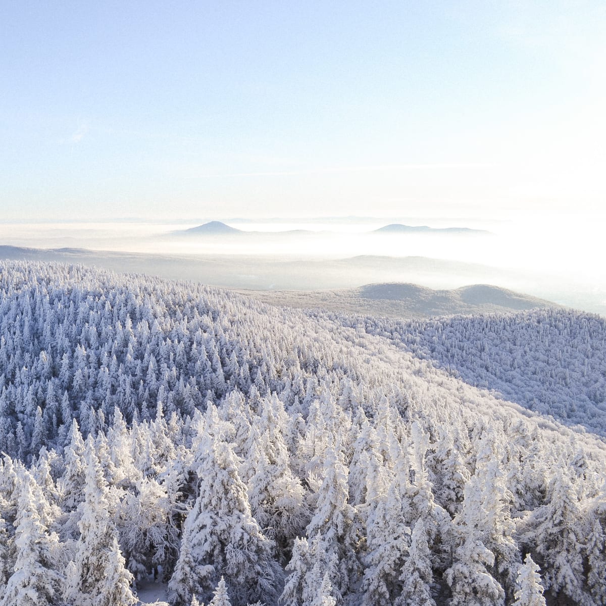 Snow-covered mountain under a blue sky.