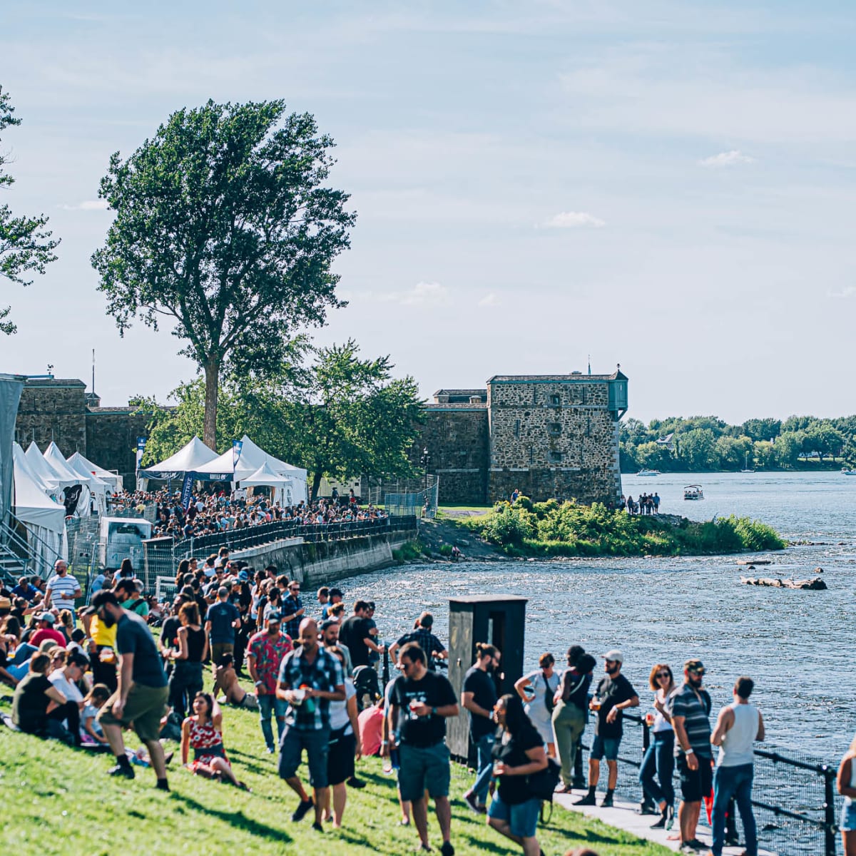 A crowd gathered by the water during a festival.
