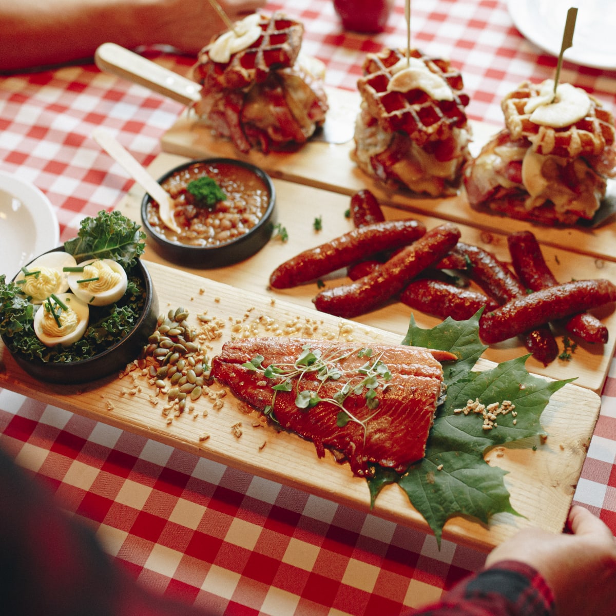 A tray of food served on a table covered with a checked tablecloth.
