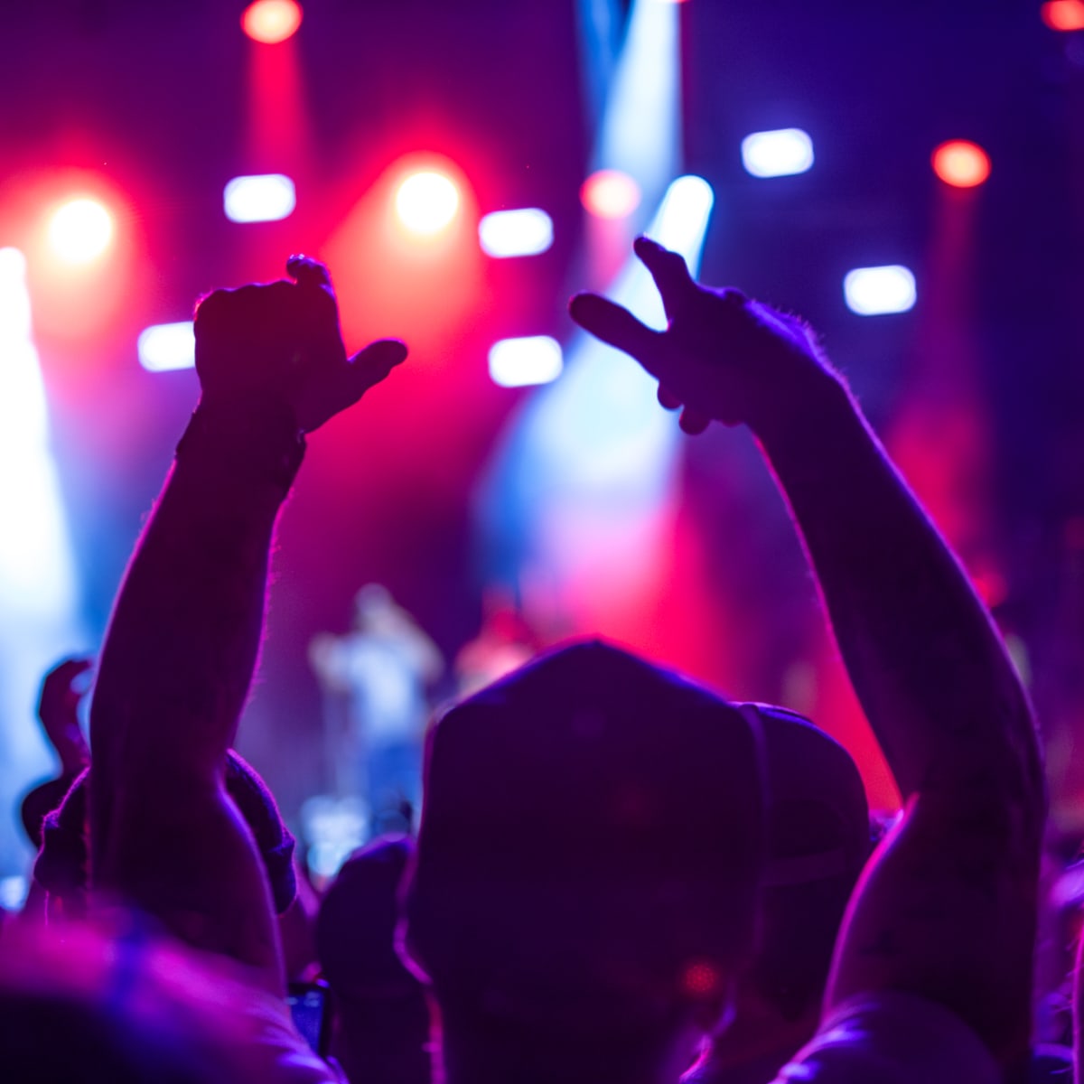 Close-up shot of a festival-goer with his back to the crowd.