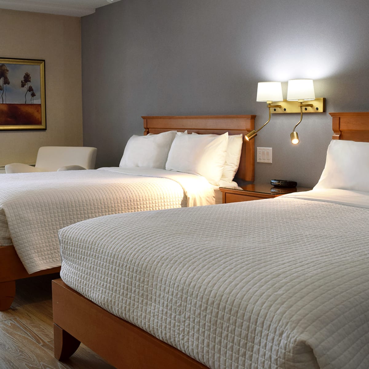 Room with two large beds at Hôtel Castel.