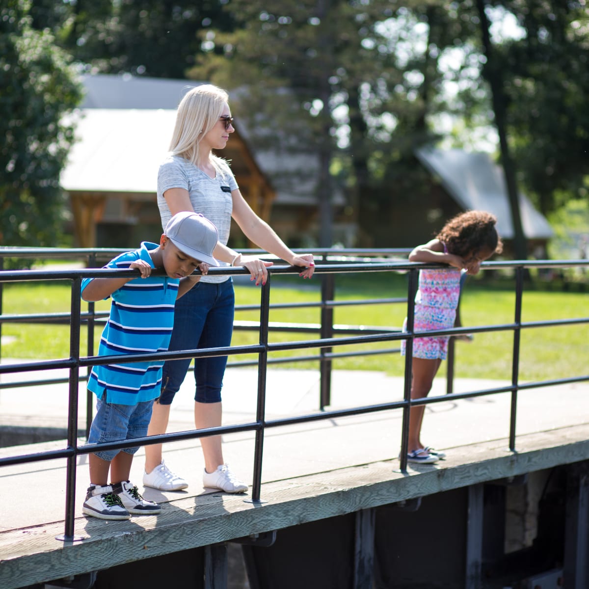 Mother and two children on the bridge at the canal