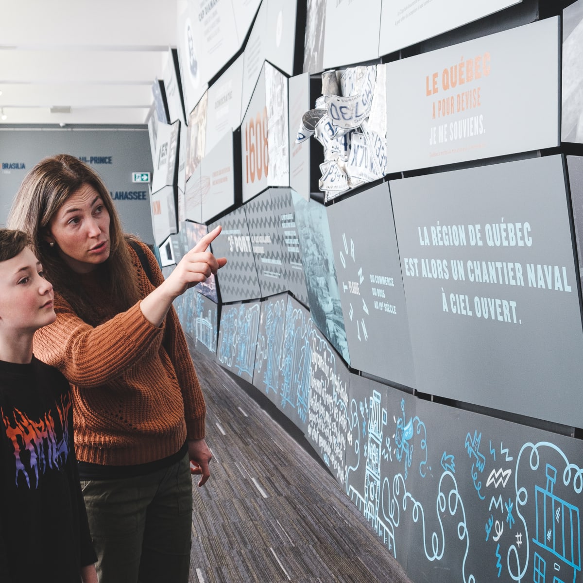 A mother and her son looking at an exhibit.