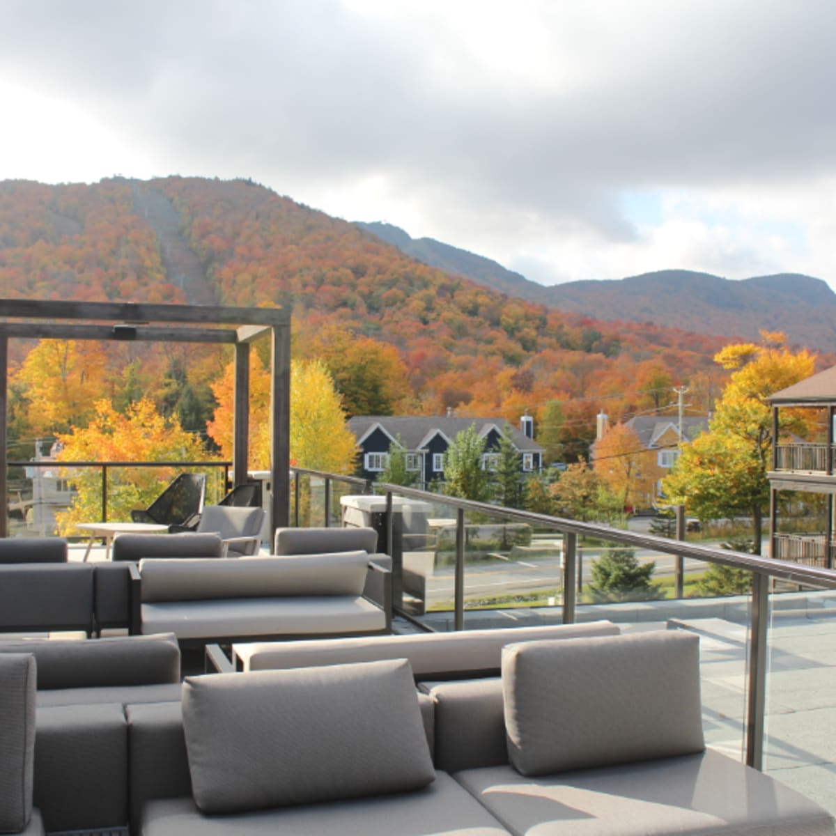 Mezzanine of the Espace 4 Saisons hotel with a view of the fall-coloured Mount Orford.