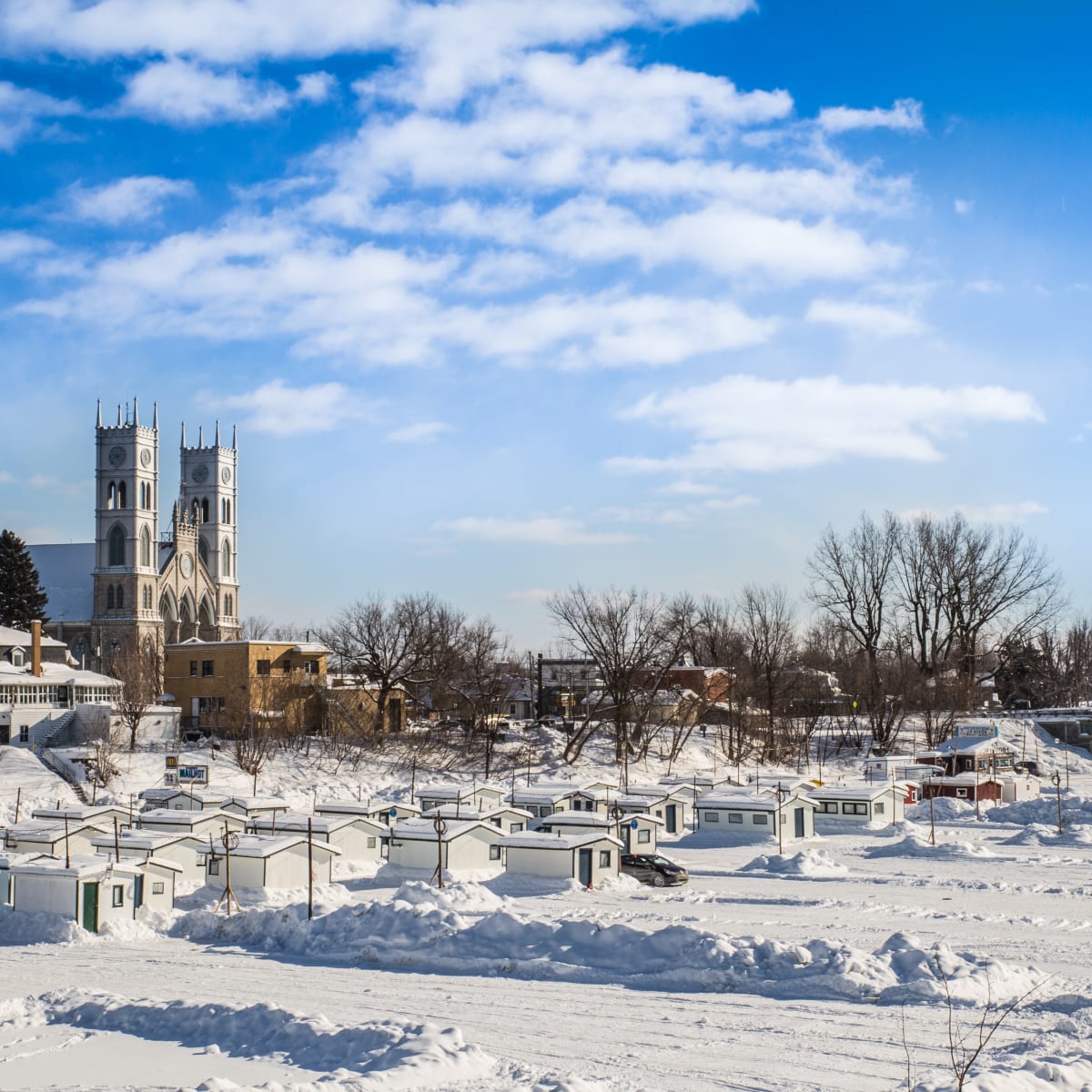 Ice fishing village in Sainte-Anne-de-la-Pérade and church in the background.