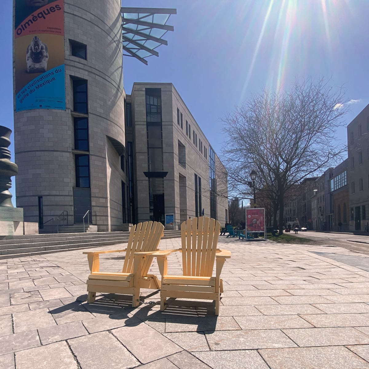 Two adirondac chairs outside Pointe-a-callière.