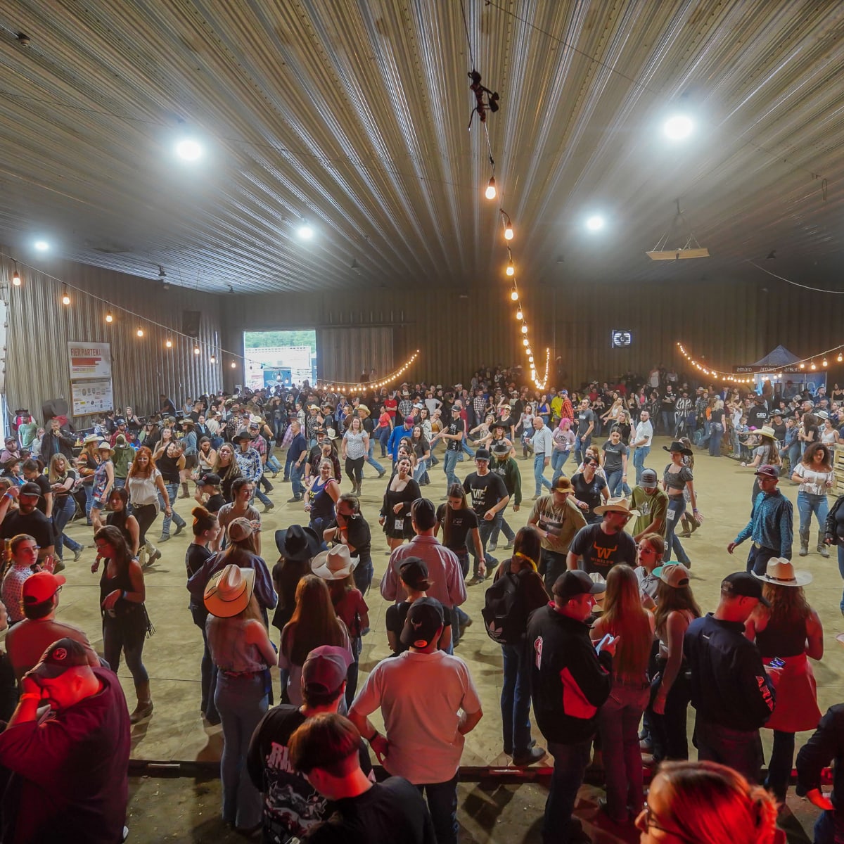 Country dancers in a barn at the Ayer's Cliff Rodeo.