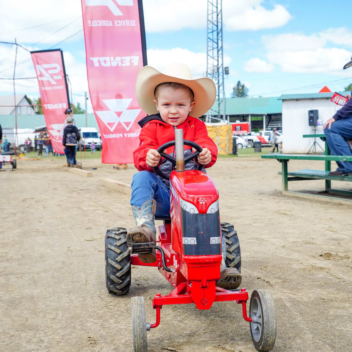 Young boy on a miniature tractor at the Ayer's Cliff Rodeo.
