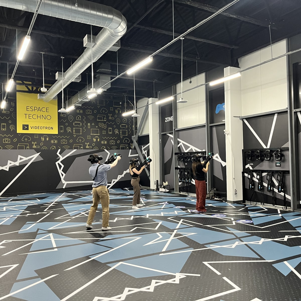 Three people in a virtual reality arena.