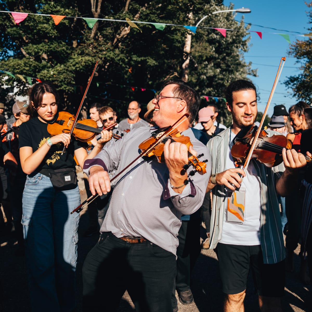 Musicians at the Ripon folk festival surrounded by a dancing audience.