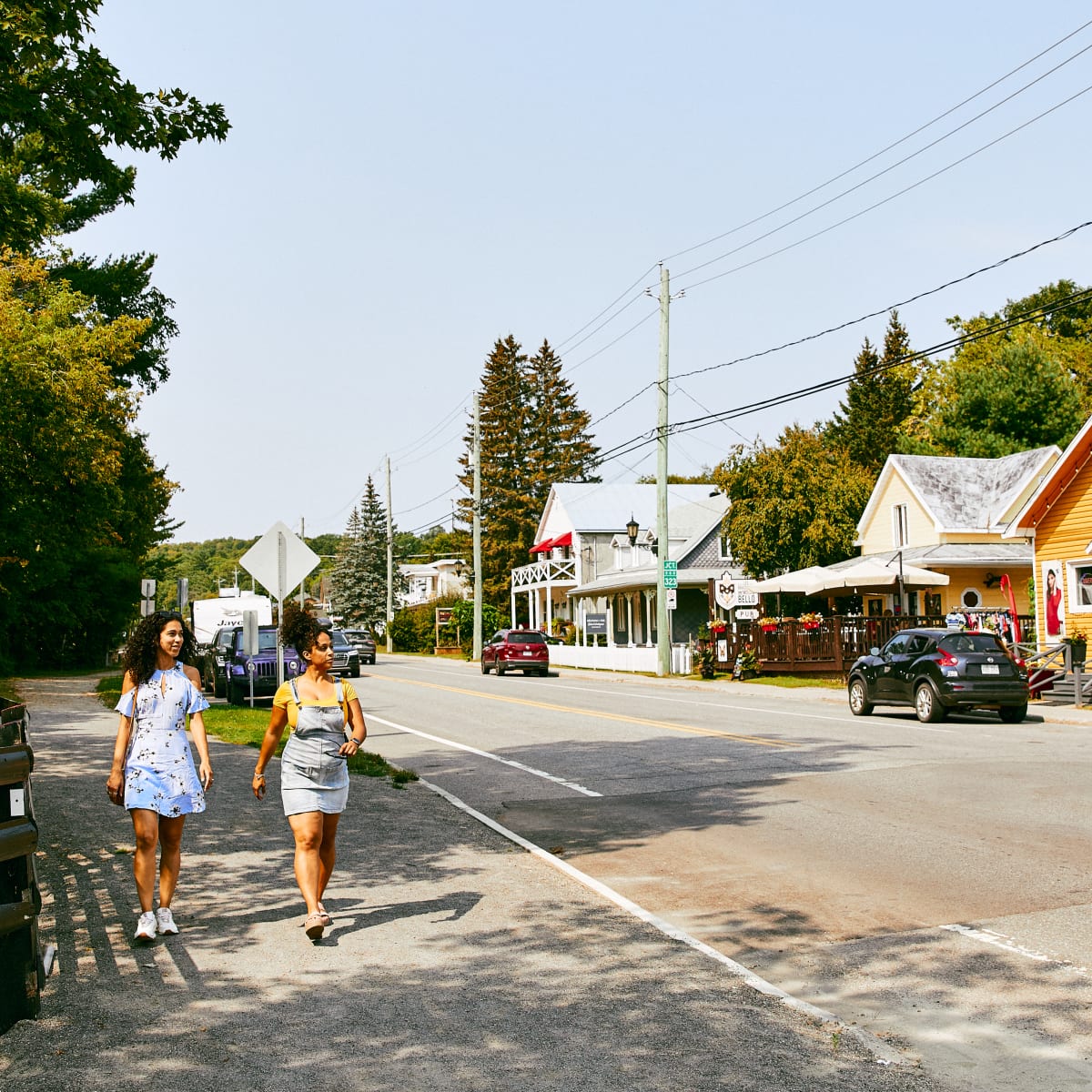 Two young girls exploring the main street in the village of Montebello.