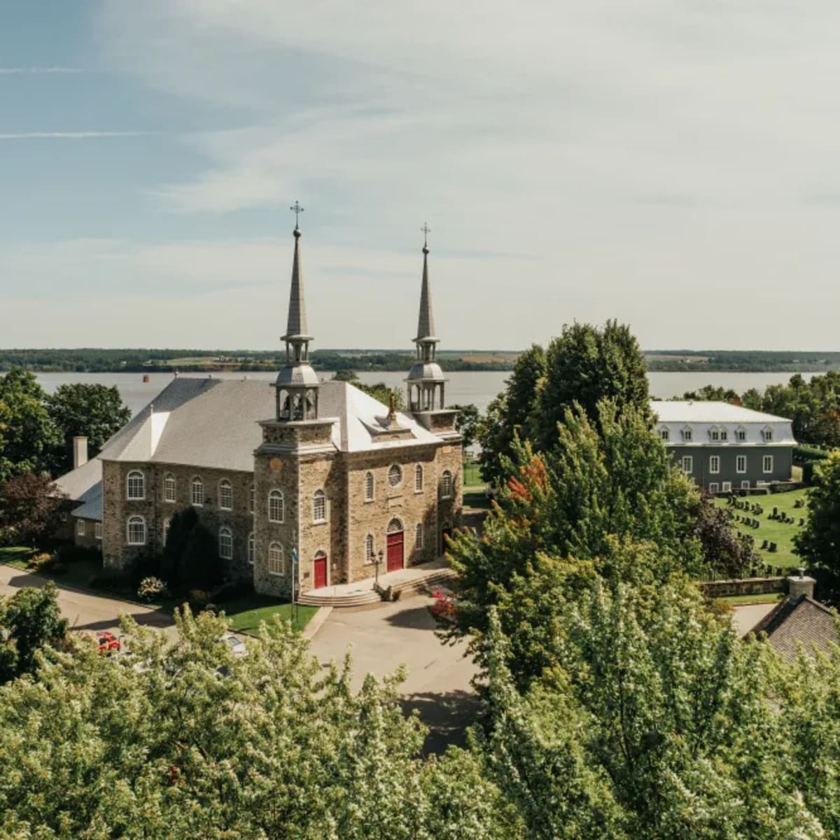 Aerial view of a church near a body of water.