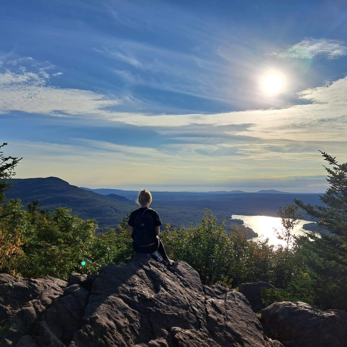 Woman on a mountain admiring the scenery.