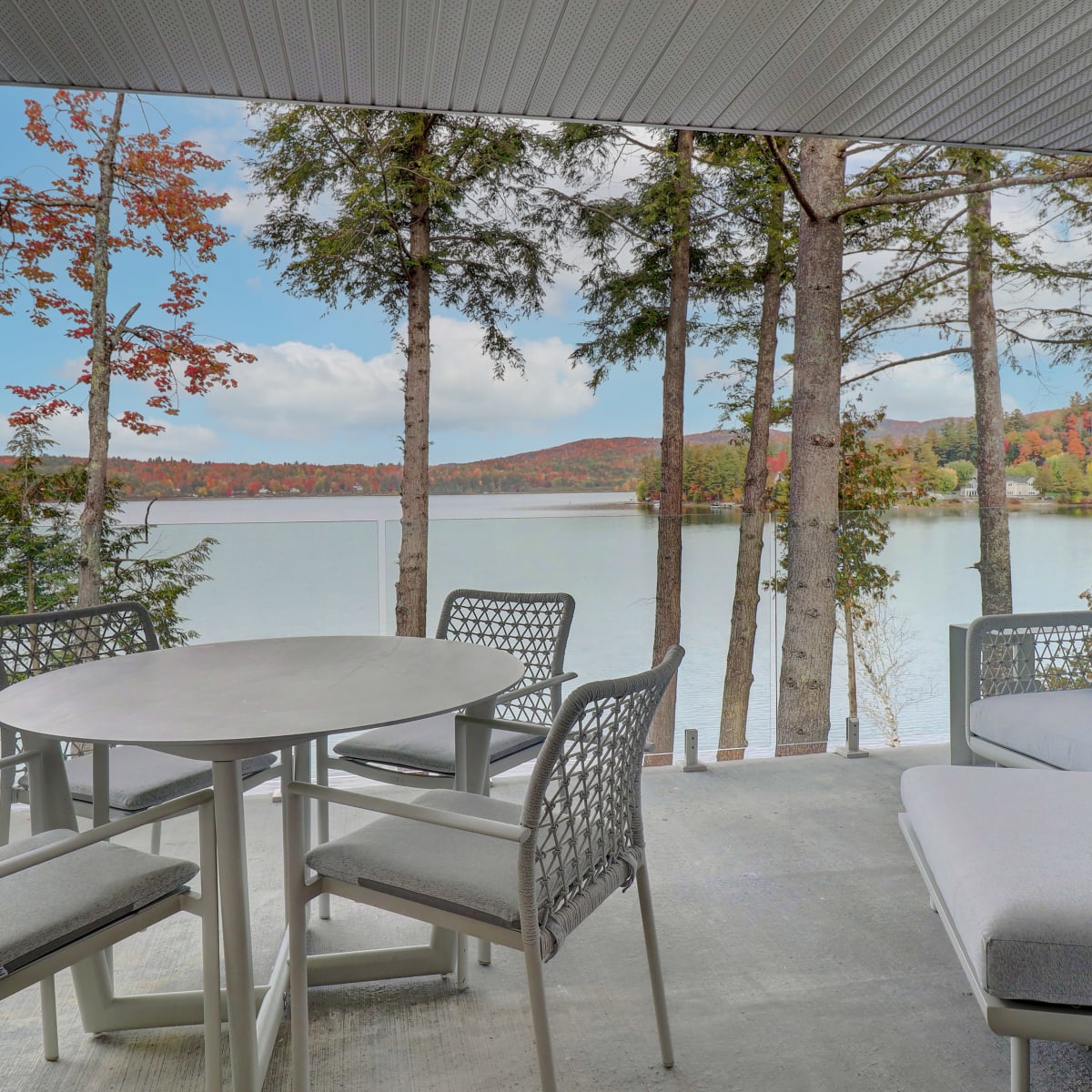 An outdoor living area by the lake in the fall.