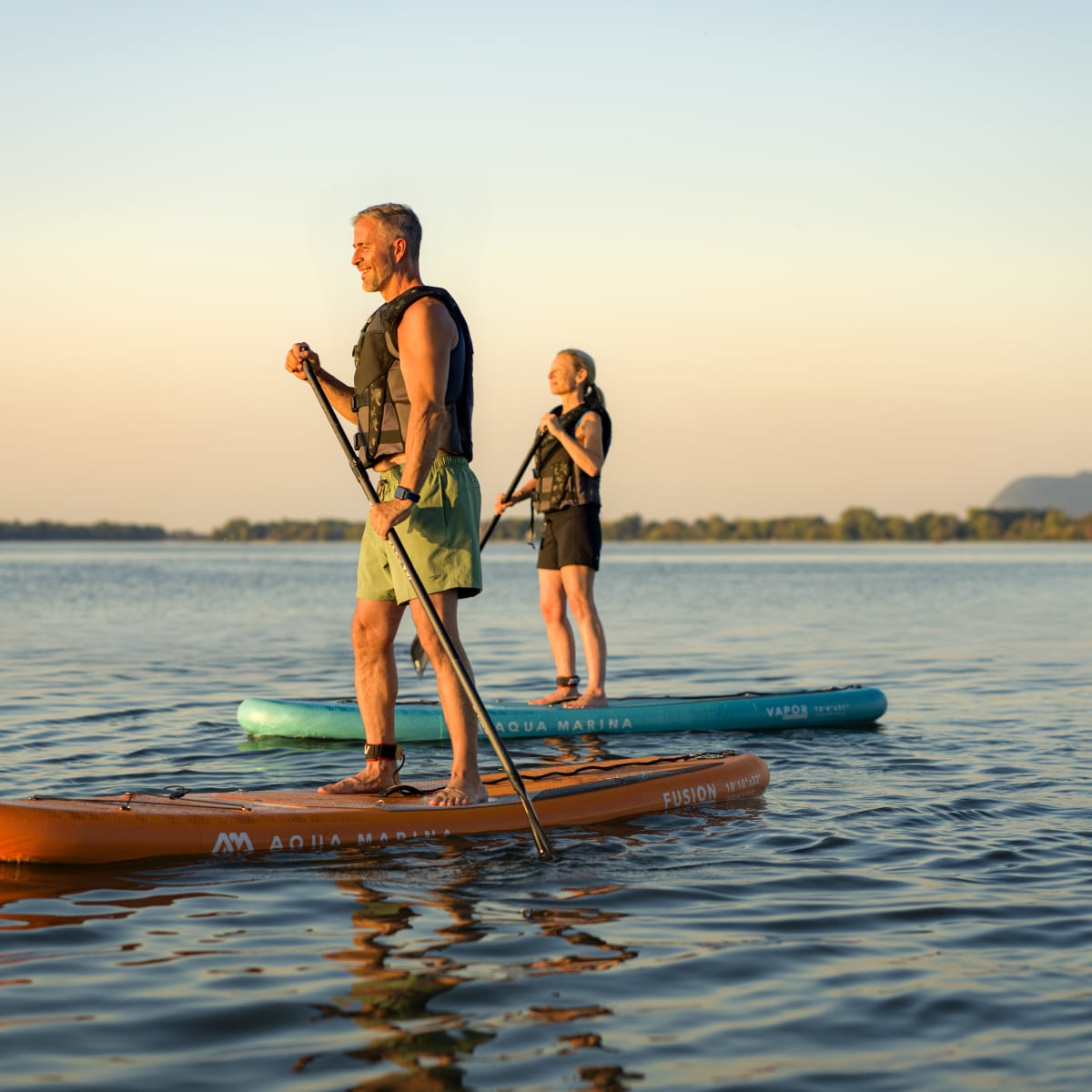 Two people paddleboarding.