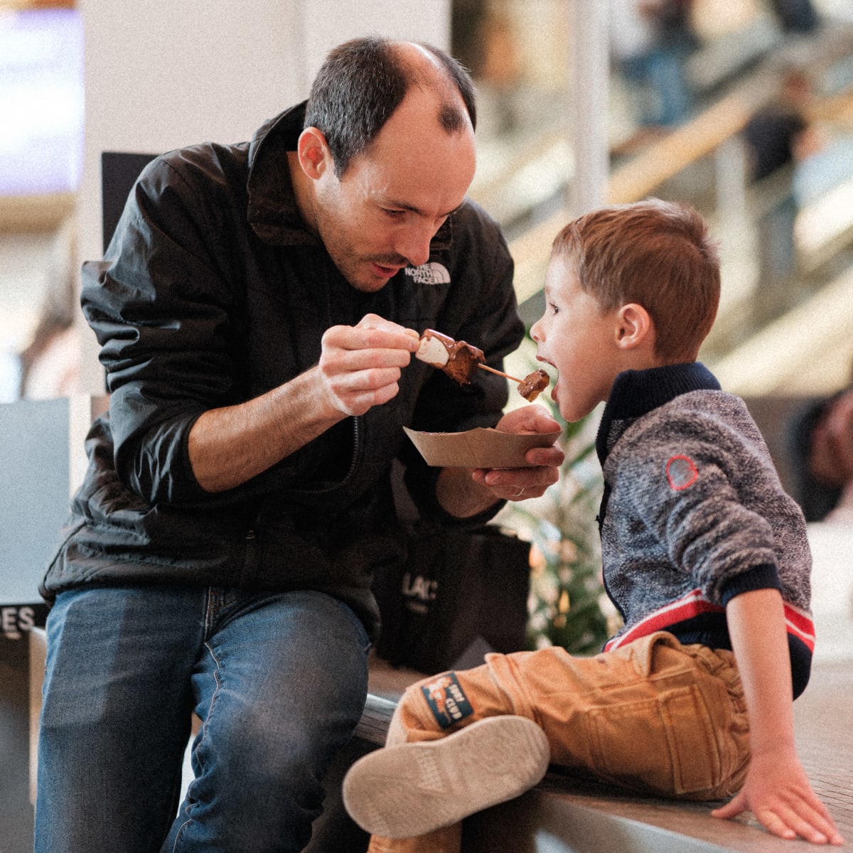 A father with his son at Salon du Chocolat de Montréal.