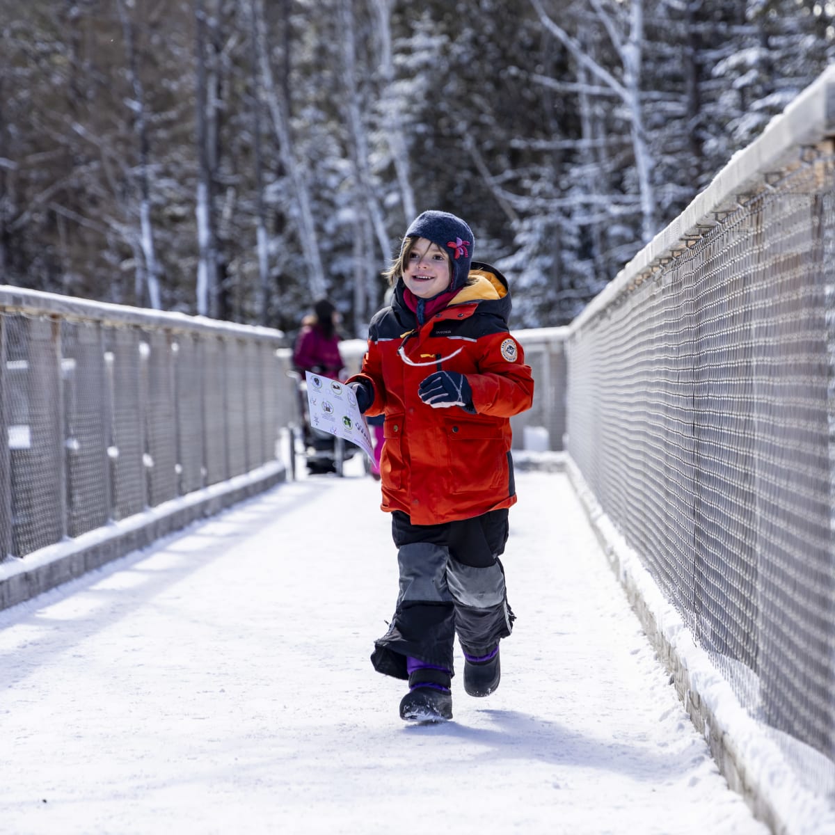 Child taking a quiz at the Sentier des Cimes. 