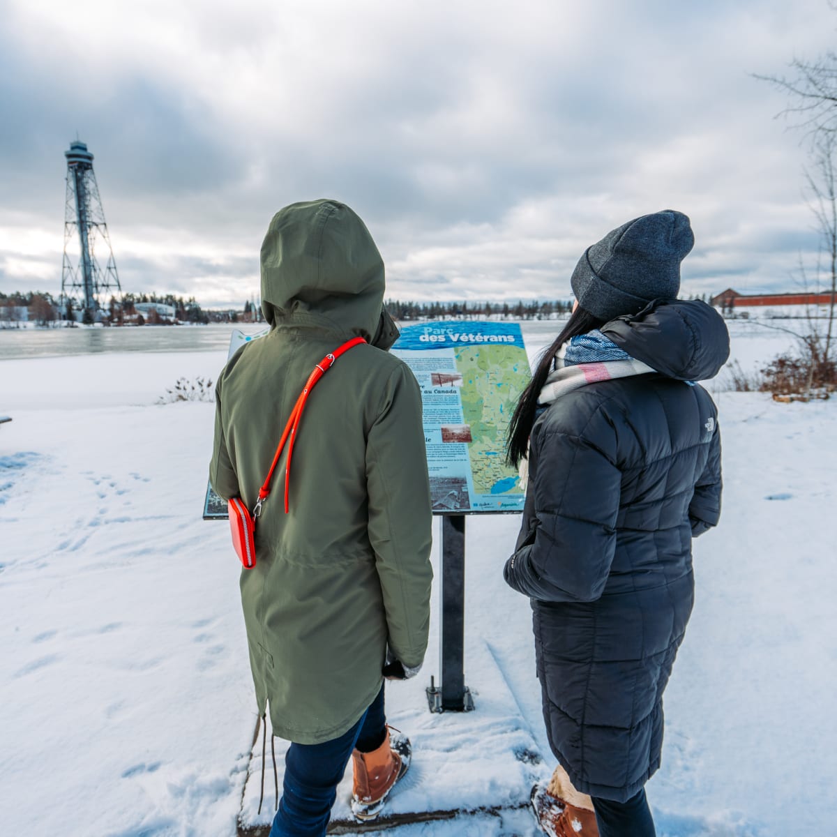 Two women in front of an information panel in Shawinigan.