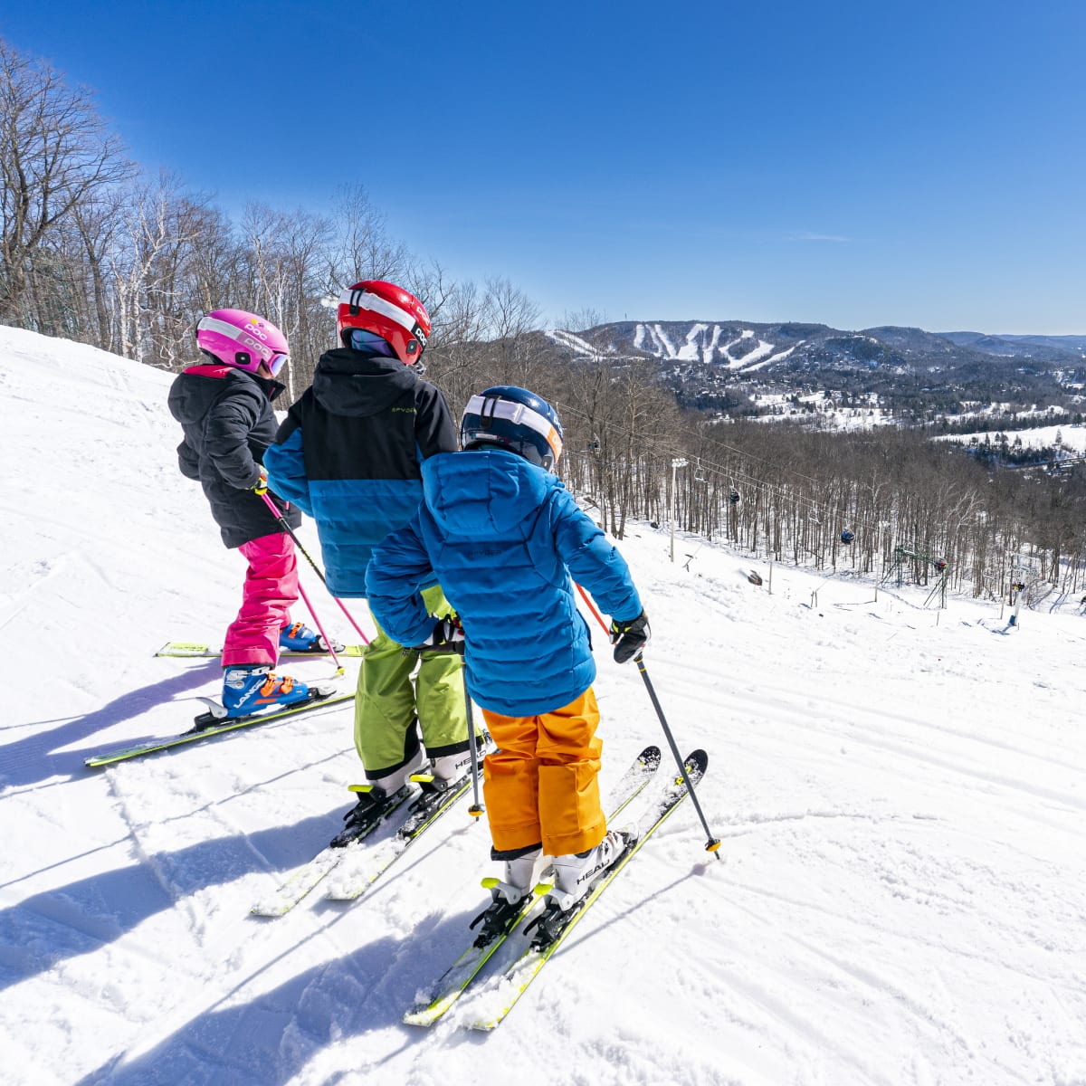 Three children skiing at Sommet Gabriel.