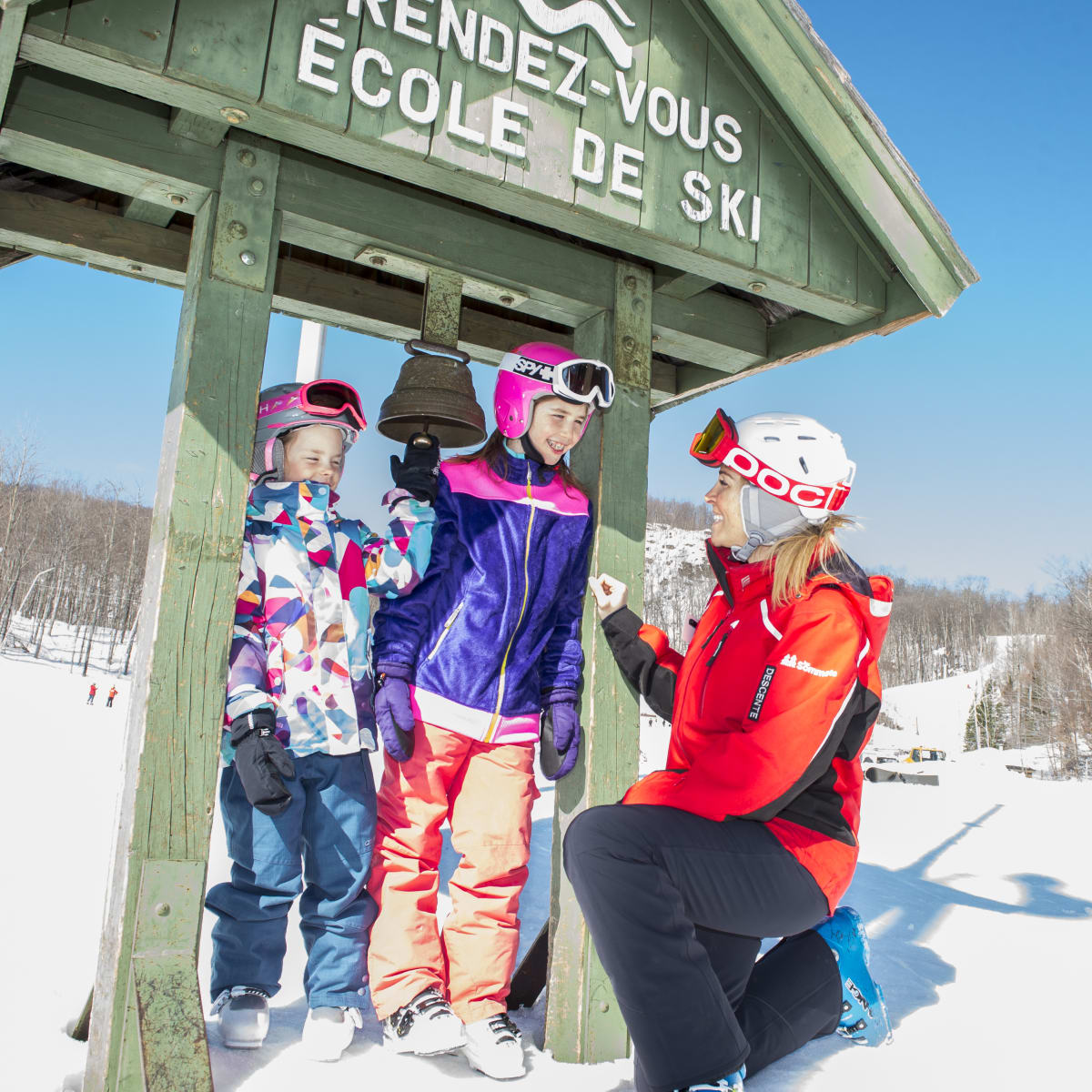 Two children with a ski instructor at Sommet Morin Heights.