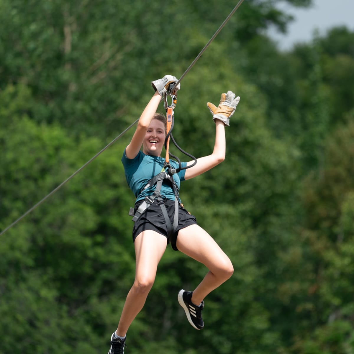 A person zip-lining at Sommet Morin Heights.