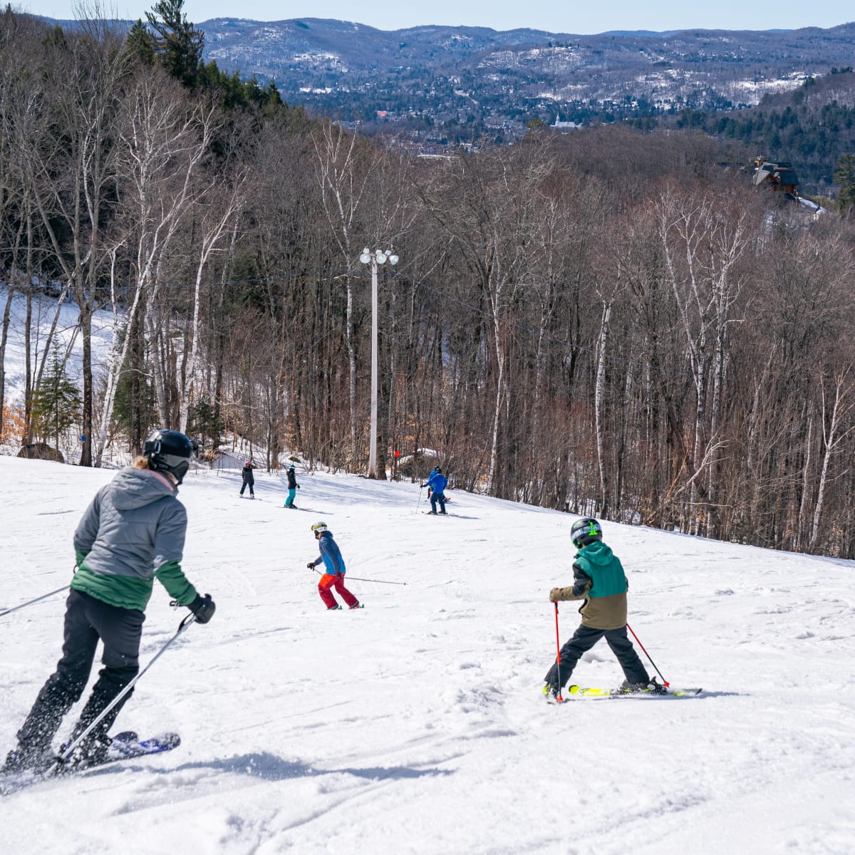 Skiers at Sommet Olympia.