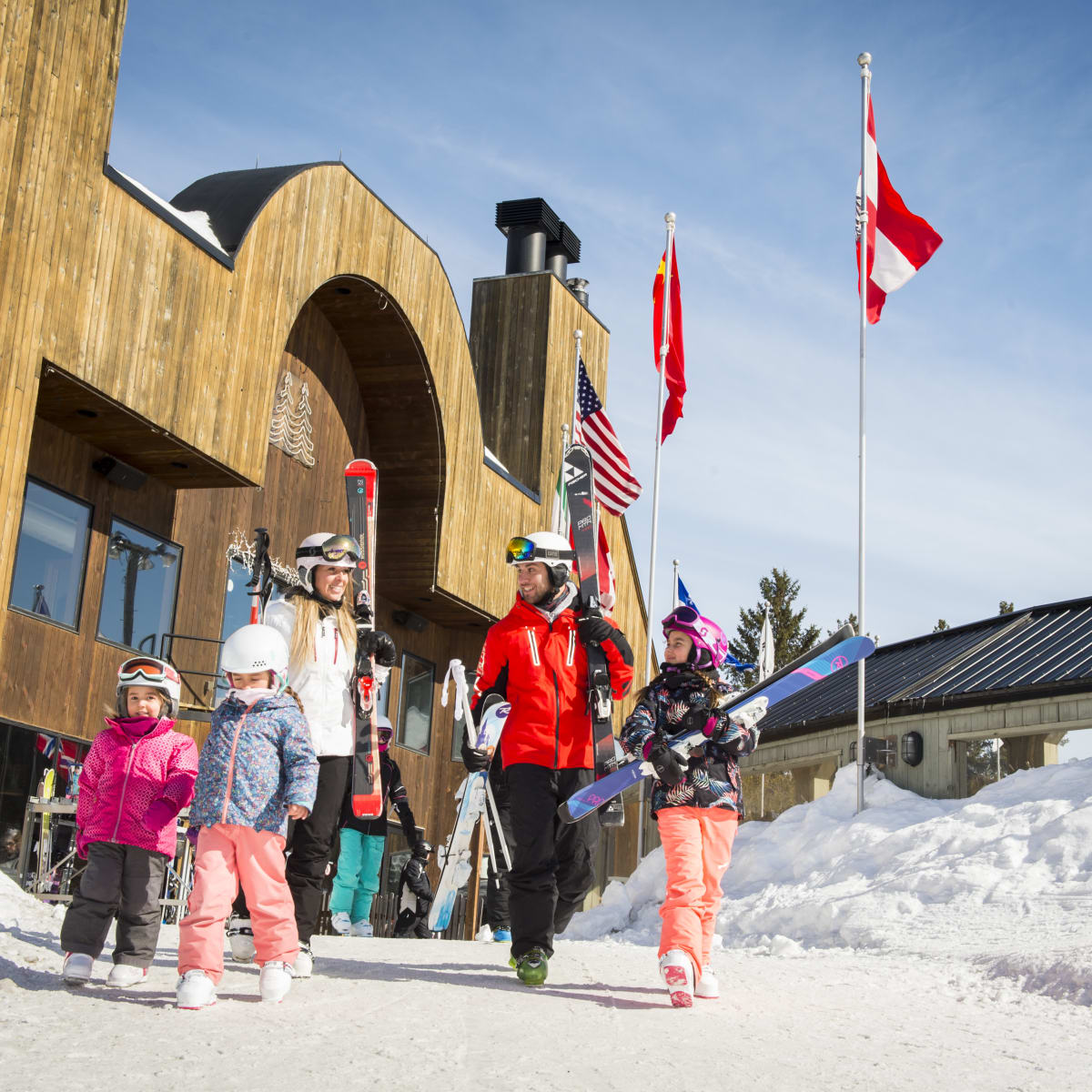Family at the bottom of the Sommet Saint-Sauveur ski mountain.