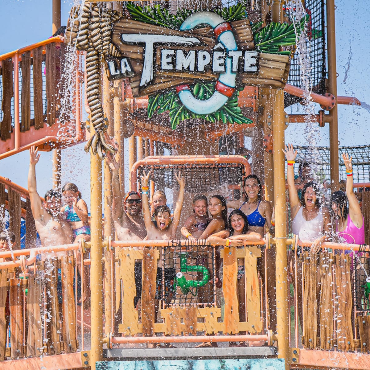 A group of people on a platform in the “La Tempête” water ride at the Super Aqua Club