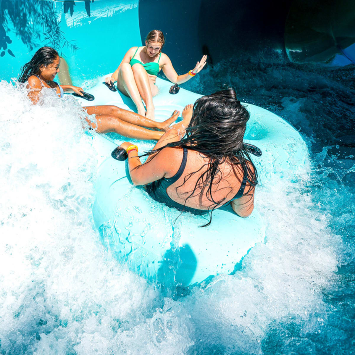 Three people on a tube slide at the Super Aqua Club