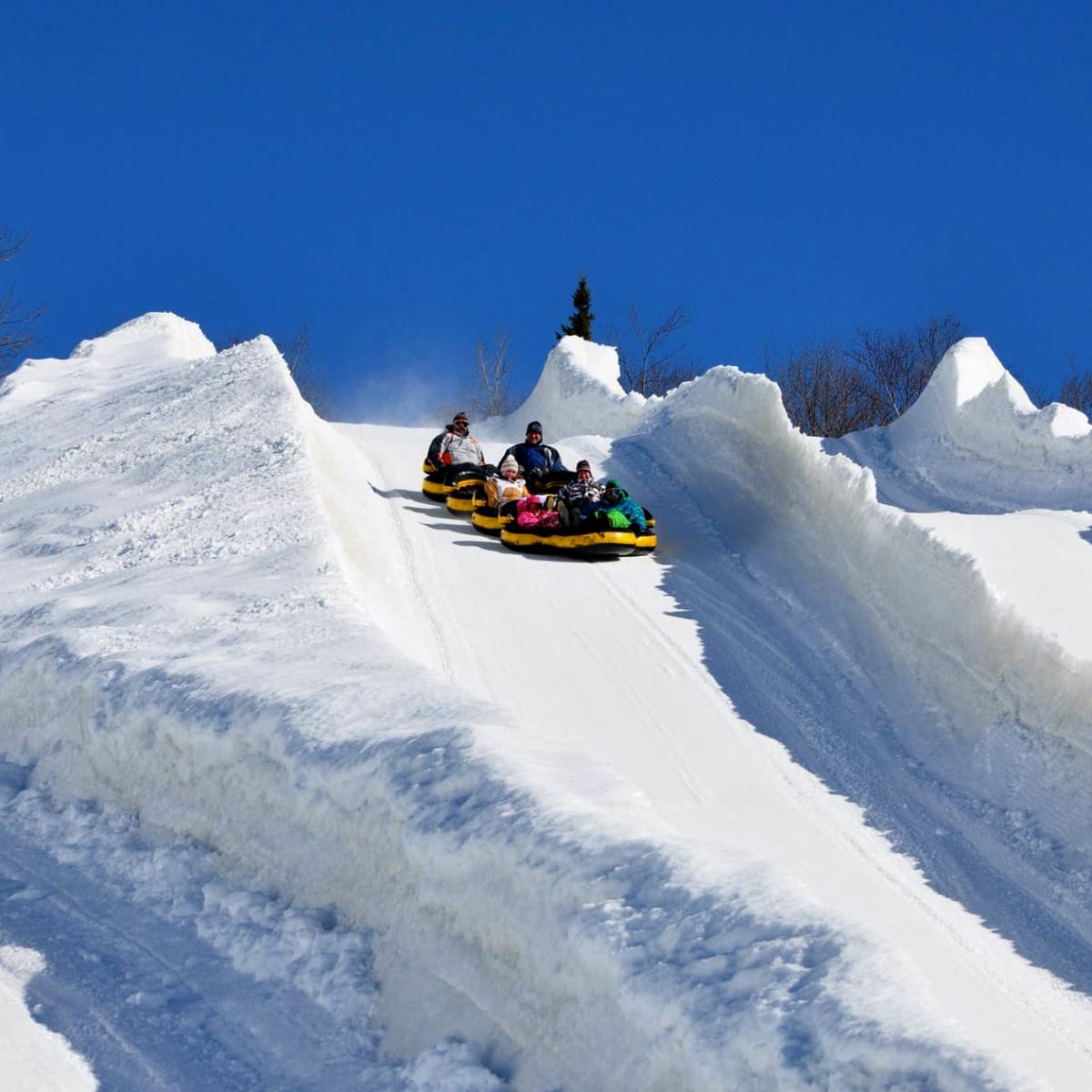 People slide down at the Super Glissades Matha.