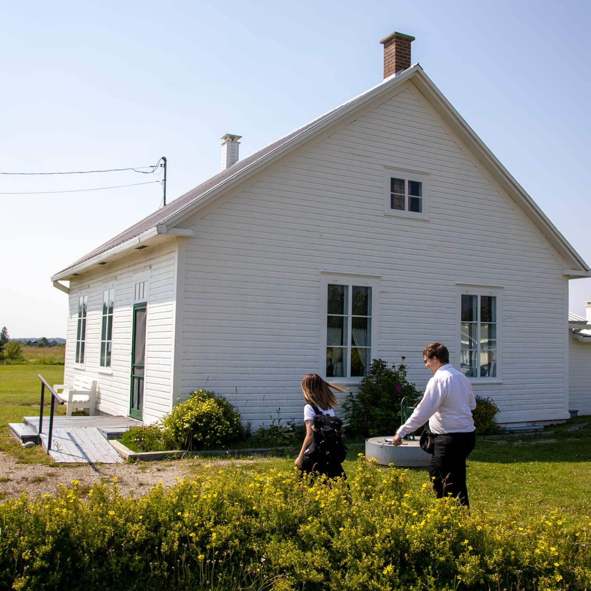Exterior of a schoolhouse museum, a quaint little white house.