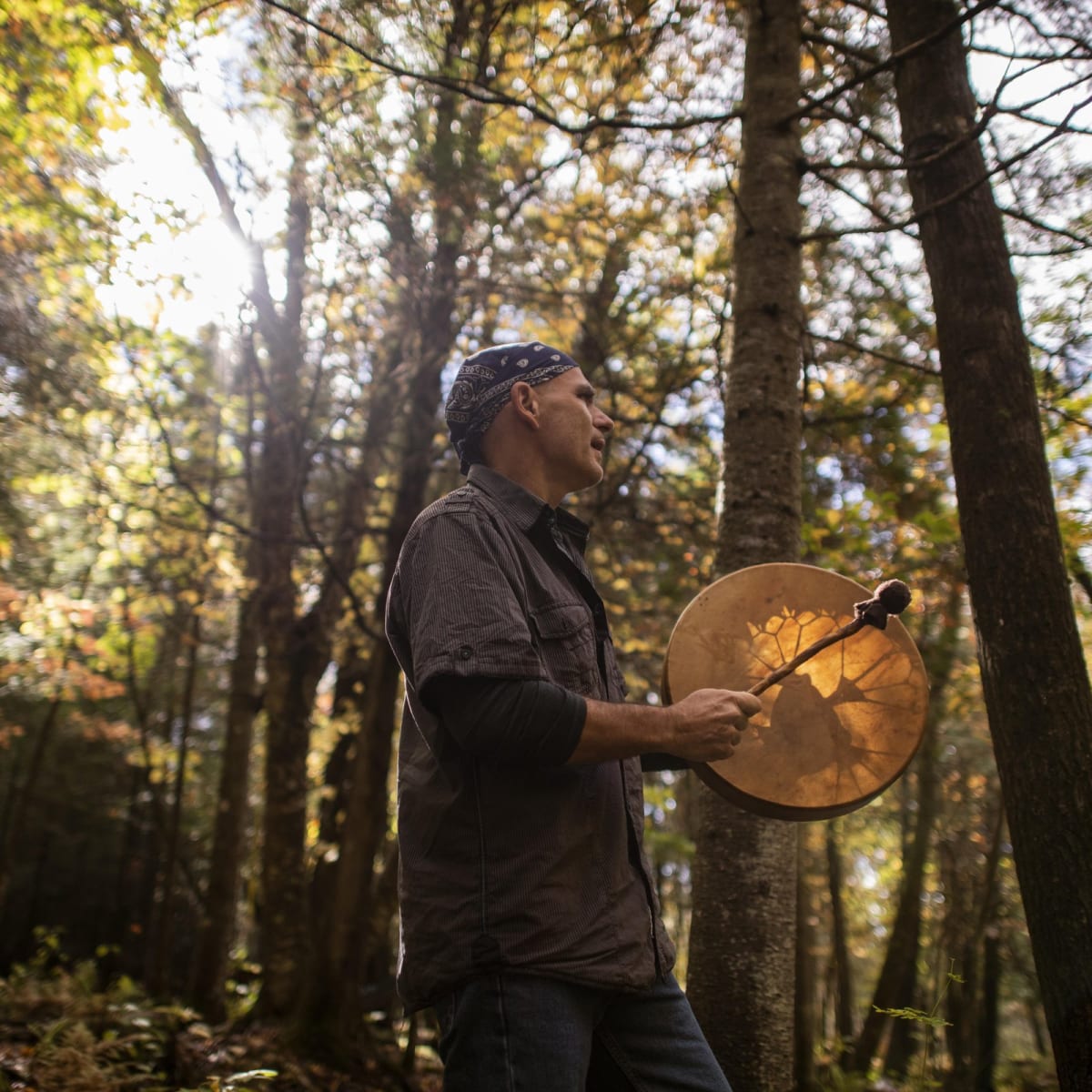 Drum player in a forest in Quebec.