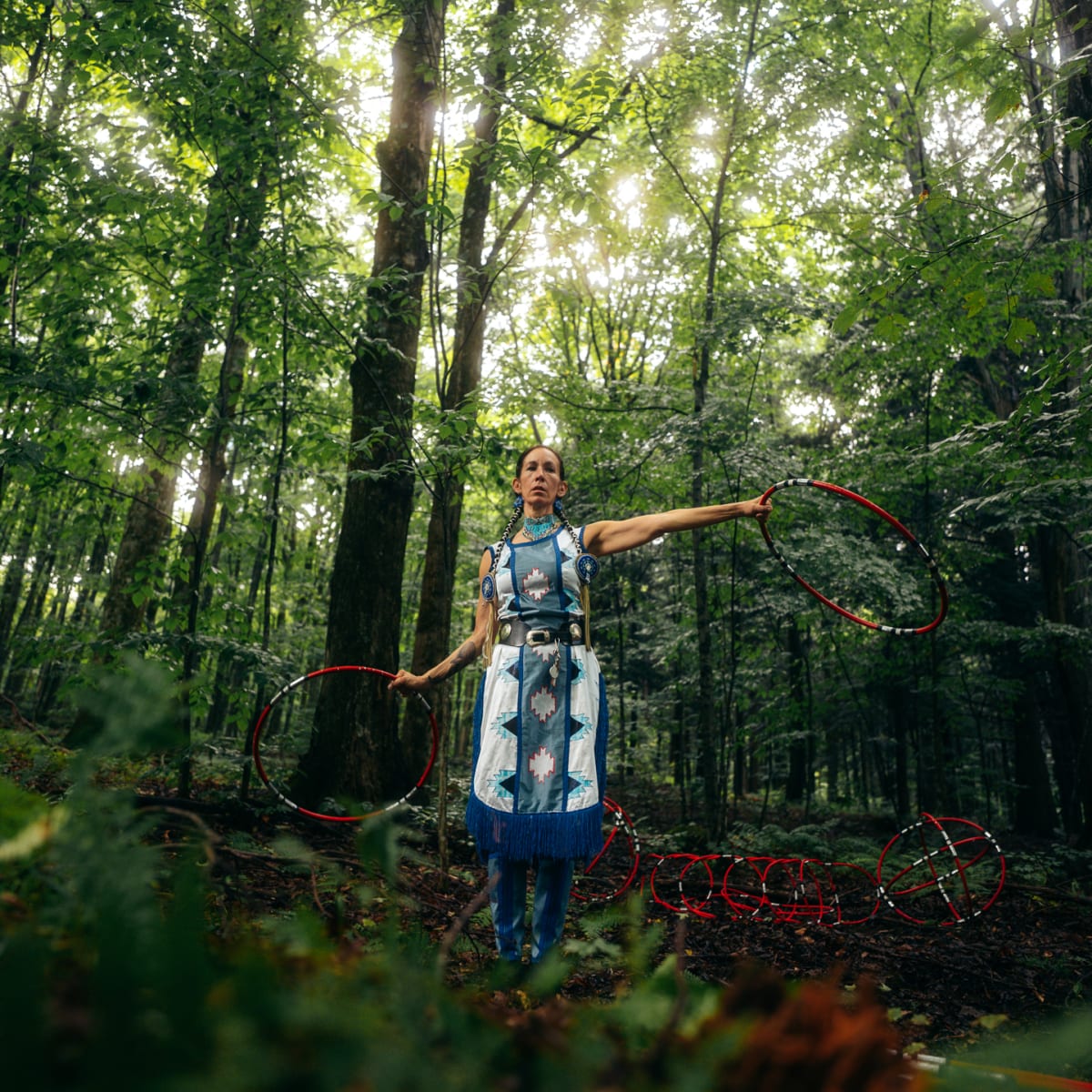 Indigenous dancer in a forest.