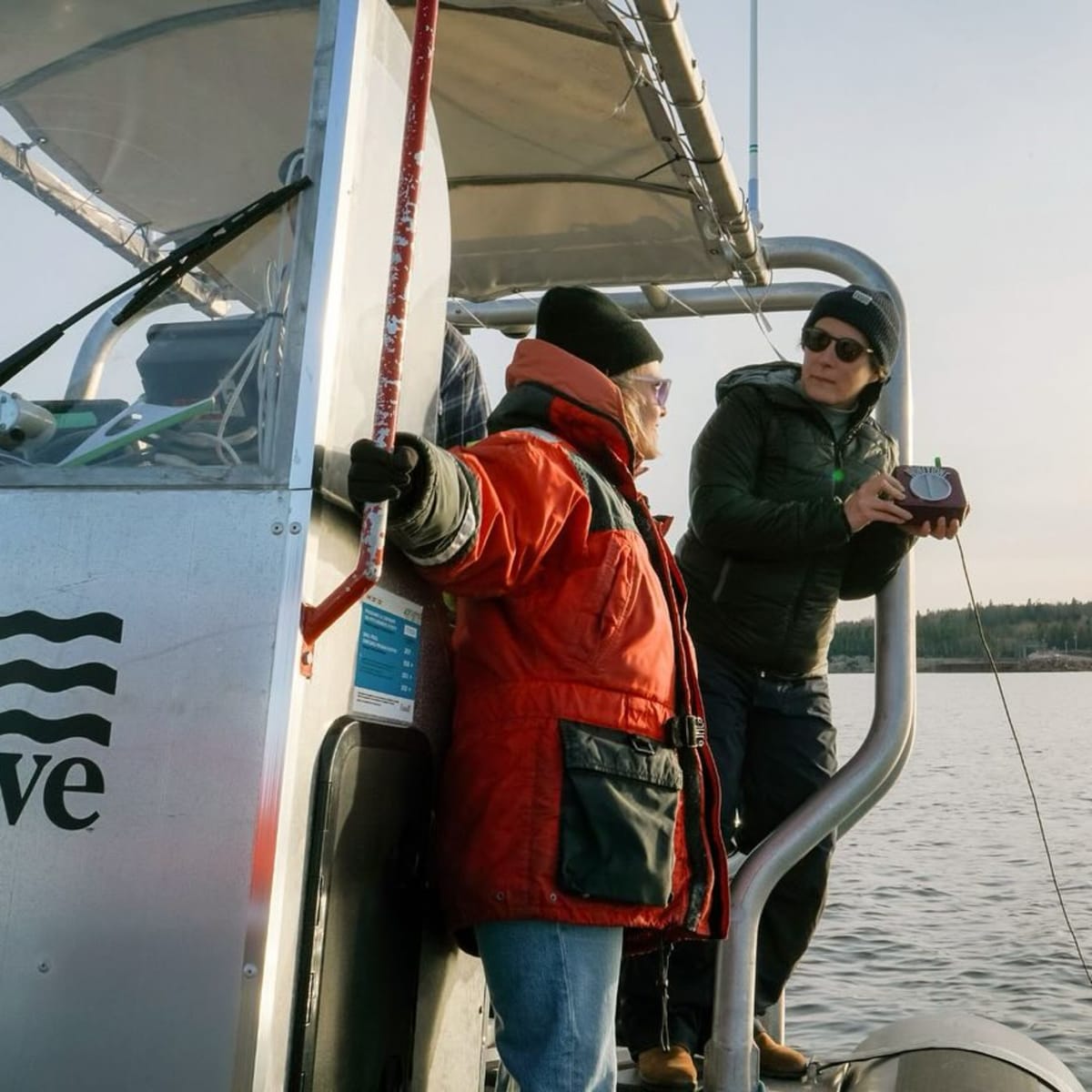 Two people on a boat in the sea.