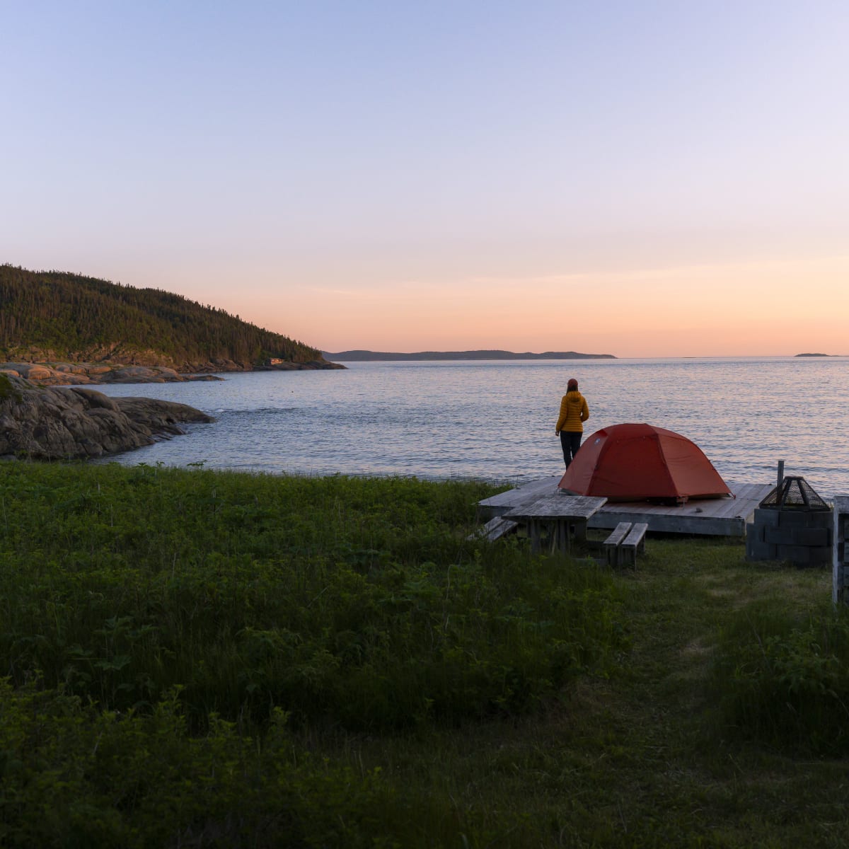 Camping by the river in the evening.