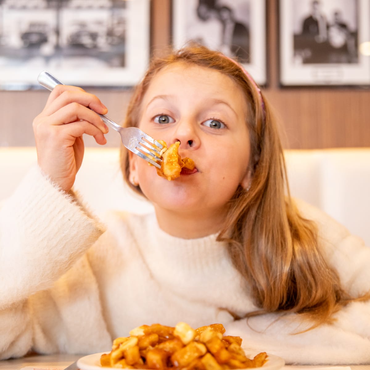 Tourisme Drummondville young girl enjoying a delicious poutine