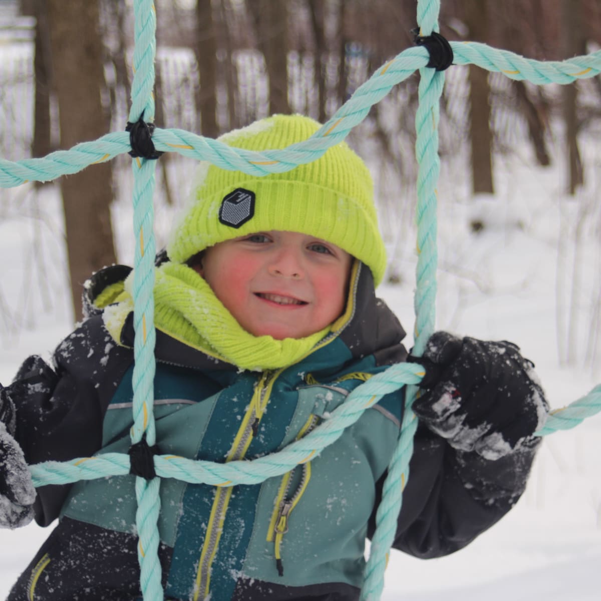 Kid in an outdoor playground in the winter.