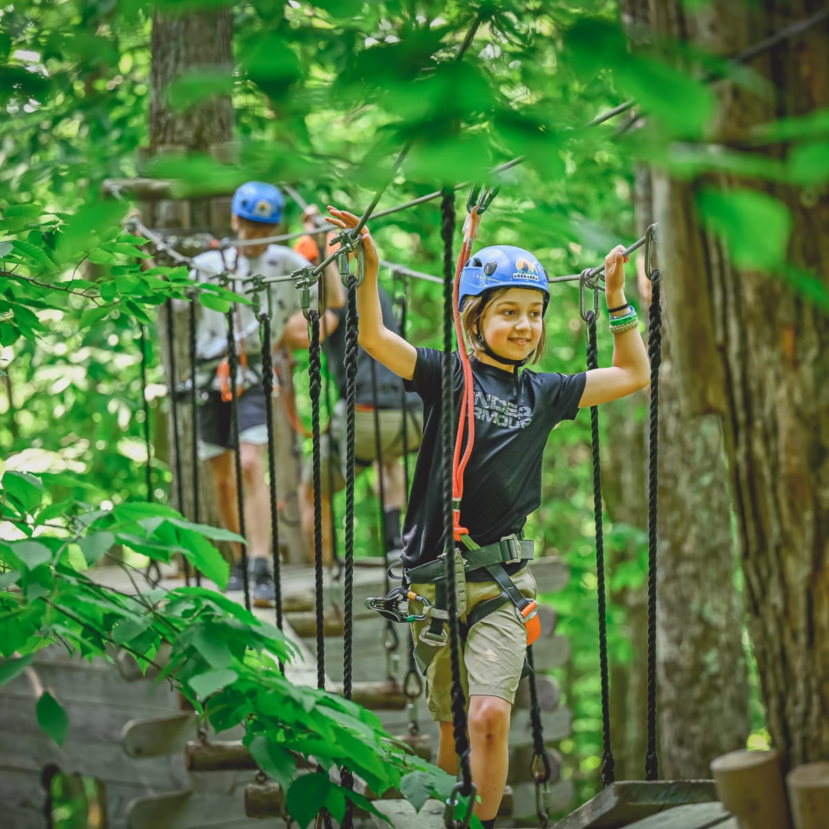 Kids in a treetop obstacle course at Arbraska Duchesnay.