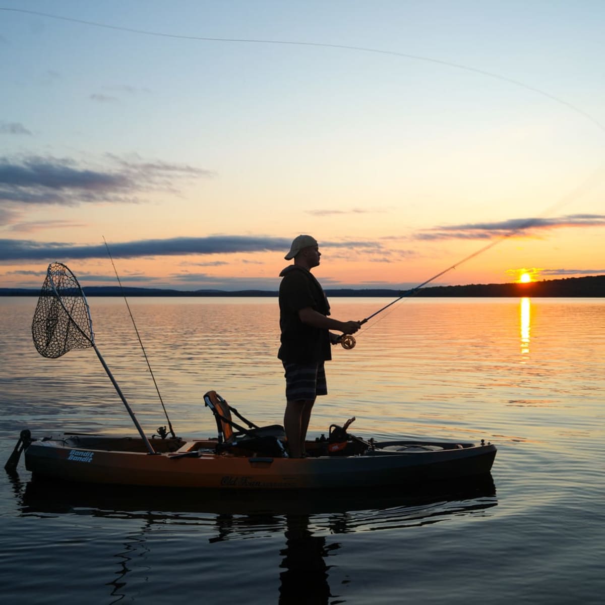 Fishing on a lake at sunrise.