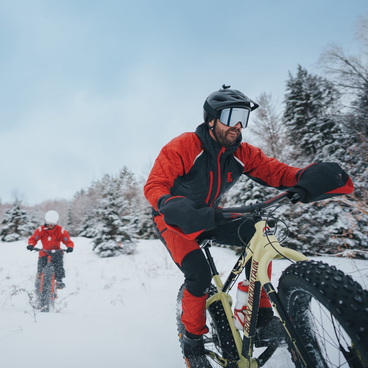 Two people riding fat bikes on a trail.