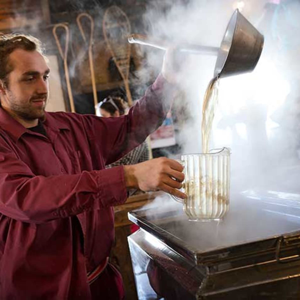 Man at the maple evaporator, Érablière Aux Trois Renards.