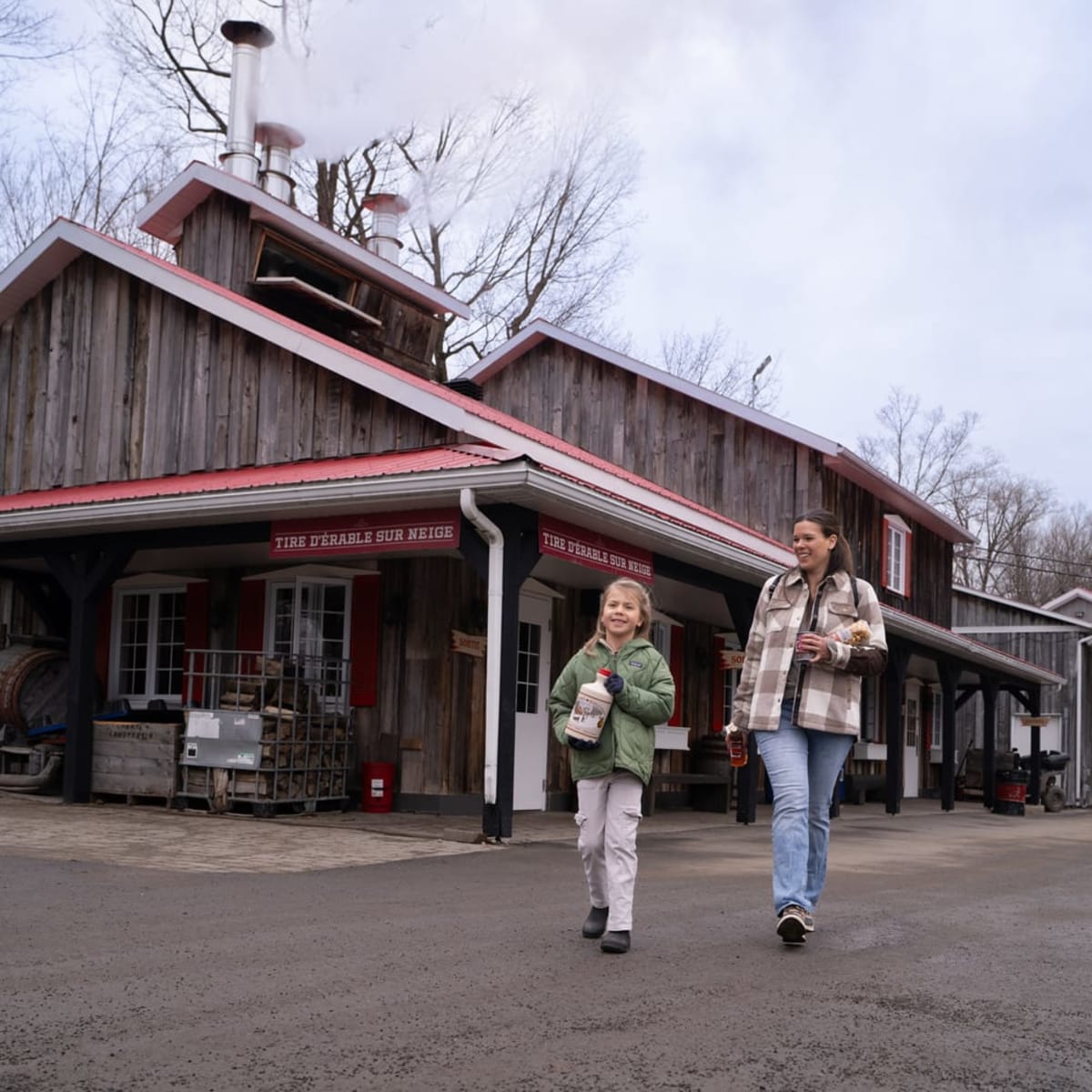 Woman and girl bringing back maple products, Sucrerie Constantin.