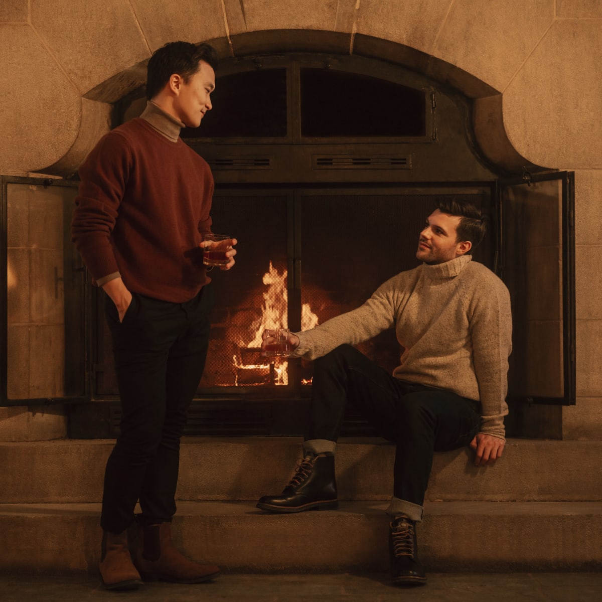 2 men in front of a fireplace at Fairmont Le Château Montebello.