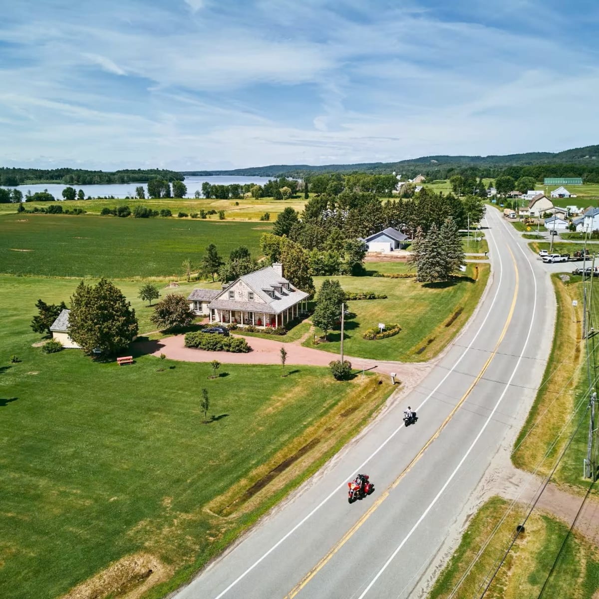 An aerial view of a country road on a sunny day.