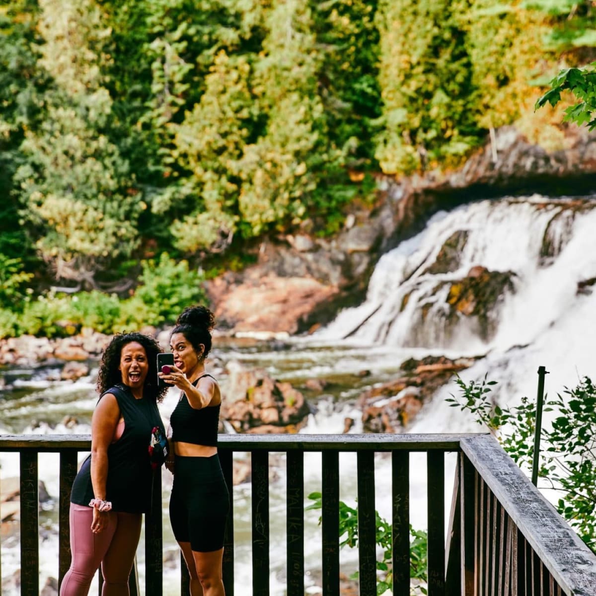 Someone in front of a waterfall.