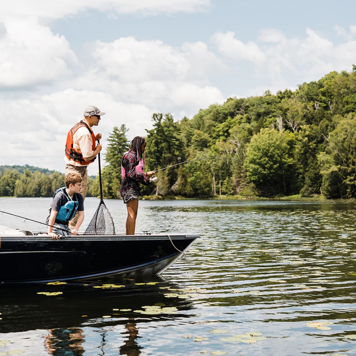 A fishing adventure in Petite Nation - Two adults and two children fishing on a small boat
