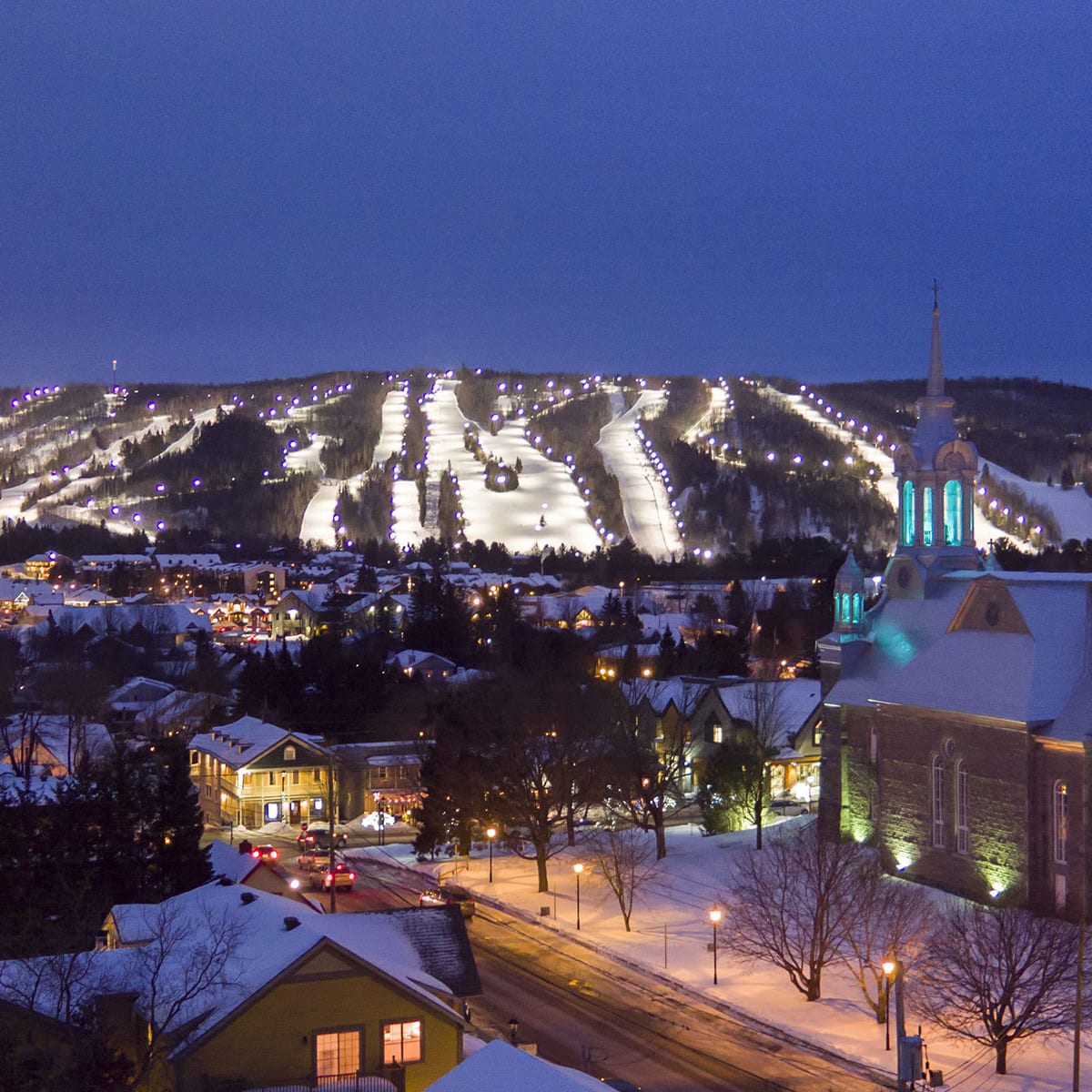 Mountain and village illuminated in winter in Vallée Saint-Sauveur.