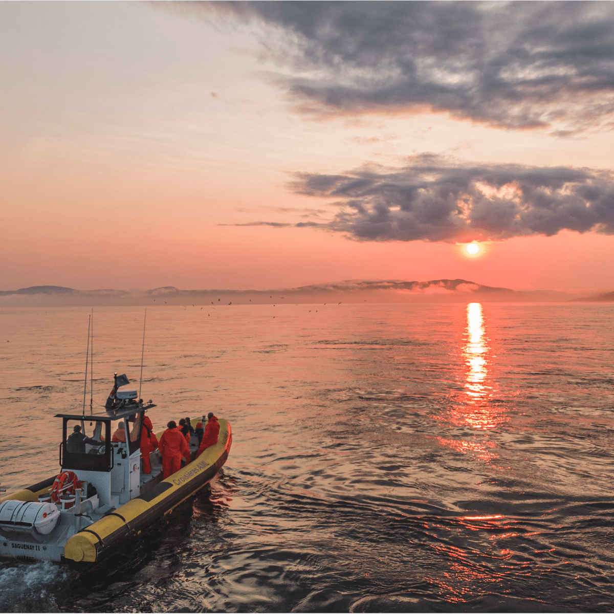 Zodiac boat on the water at sunset