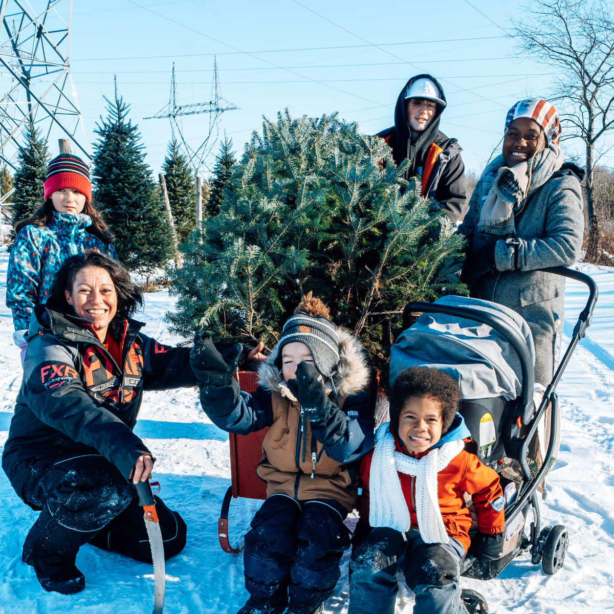 A family with a Christmas tree at the Village de Noël - Sapins Goupil.